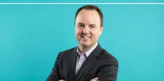 Rhett Hintze PR Leader standing in a modern Pennsylvania office — professional biography photo
