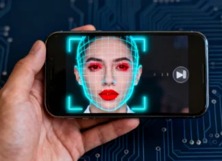 How to Identify Deepfake Video on Phone: 2026 Complete Guide Person trying to identify deepfake video on phone with AI detection overlay on screen