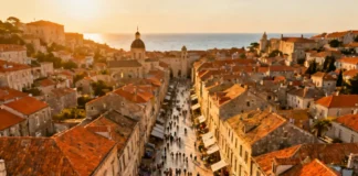 Aerial view of overtourism effects on travelers at a crowded European coastal city with cruise ships in harbor
