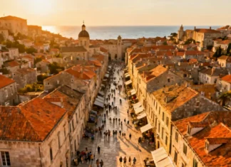 Overtourism Effects on Travelers: What’s Changing in 2026 Aerial view of overtourism effects on travelers at a crowded European coastal city with cruise ships in harbor
