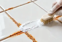 How to Remove Rust Stains from Bathroom Tiles (Step-by-Step Guide) Close-up of a person scrubbing rust stains off white remove rust stains from bathroom tiles using a brush and natural cleaning solution
