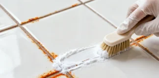 How to Remove Rust Stains from Bathroom Tiles (Step-by-Step Guide) Close-up of a person scrubbing rust stains off white remove rust stains from bathroom tiles using a brush and natural cleaning solution