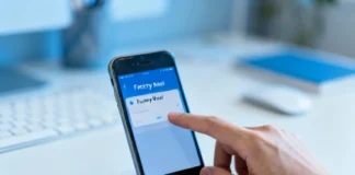 Person securely wiping old smartphone before selling to protect personal data