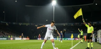 offside rule in soccer — referee raising flag with VAR screen showing digital offside line in background