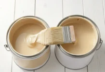 Latex Paint vs Oil-Based Paint: Which One Should You Choose in 2026? Two open paint cans showing Latex Paint vs Oil-Based Paint side by side with a paintbrush on a white wooden surface