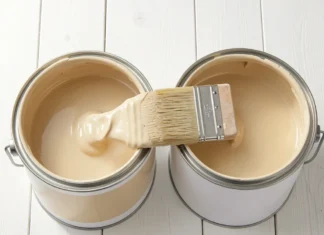 Latex Paint vs Oil-Based Paint: Which One Should You Choose in 2026? Two open paint cans showing Latex Paint vs Oil-Based Paint side by side with a paintbrush on a white wooden surface