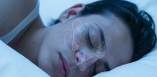 Person sleeping with nasal anatomy diagram showing how nose shape affects breathing during sleep