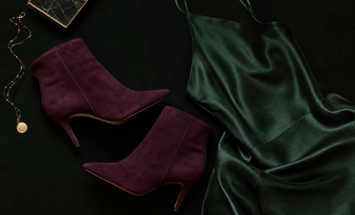 Suede ankle boots styled with a satin slip skirt for evening wear