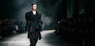 Model wearing an asymmetric avant-garde coat with sculptural shoulder, illustrating avant garde fashion style