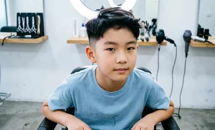 Boys fade haircut with clean low fade and neat sides at barber shop