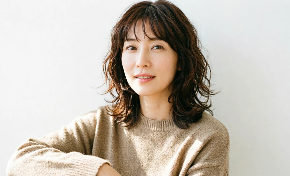 Woman with curtain bangs and lob haircut that makes you look younger, soft center part, collarbone length waves