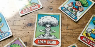 Original Topps garbage pail kids value cards including Adam Bomb spread on a wooden table