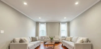 Staged living room showing interior design home resale value with neutral walls, hardwood floors and layered lighting