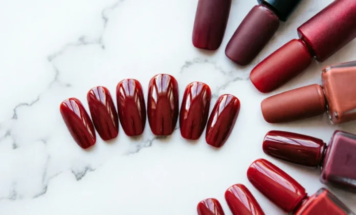 Top red nail ideas for 2026 including glossy crimson almond nails on a white marble background