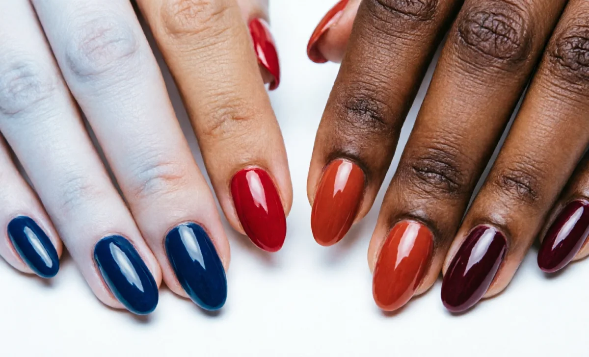 Red nail ideas for four skin tones — crimson on fair skin, true red on medium, brick red on warm brown, burgundy on deep skin
