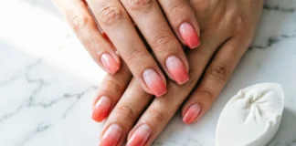 Sponge ombre nails with pink to coral gradient created using a makeup wedge sponge at home on natural nails