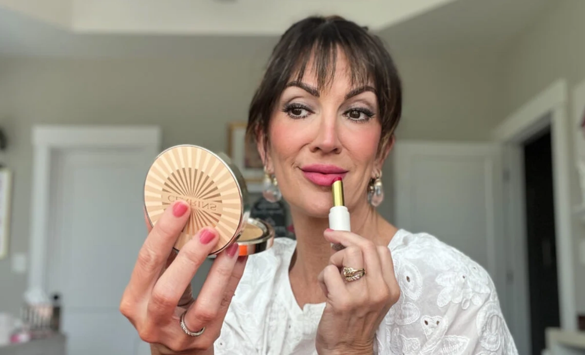 Woman demonstrating proper application technique for makeup sets for mature skin using a damp sponge