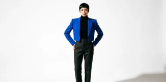 Flamboyant gamine body type woman wearing cropped blazer and tapered pants