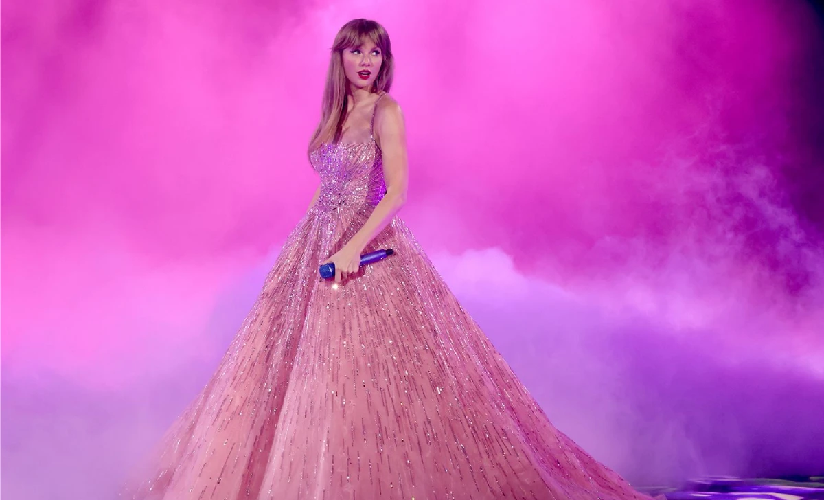 Taylor swift eras tour outfits: pink crystal bodysuit and blazer worn during the Lover era opening segment.