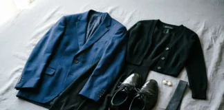 What to wear to a funeral — dark suit, black dress, and polished shoes flat-lay